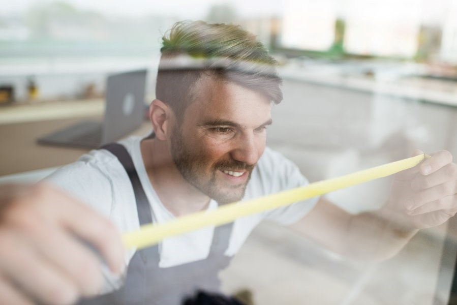 Rosati windows worker measuring a window of a house in Columbus, OH